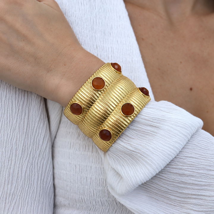 gold statement cuff bracelet with brown stones inlay worn on model