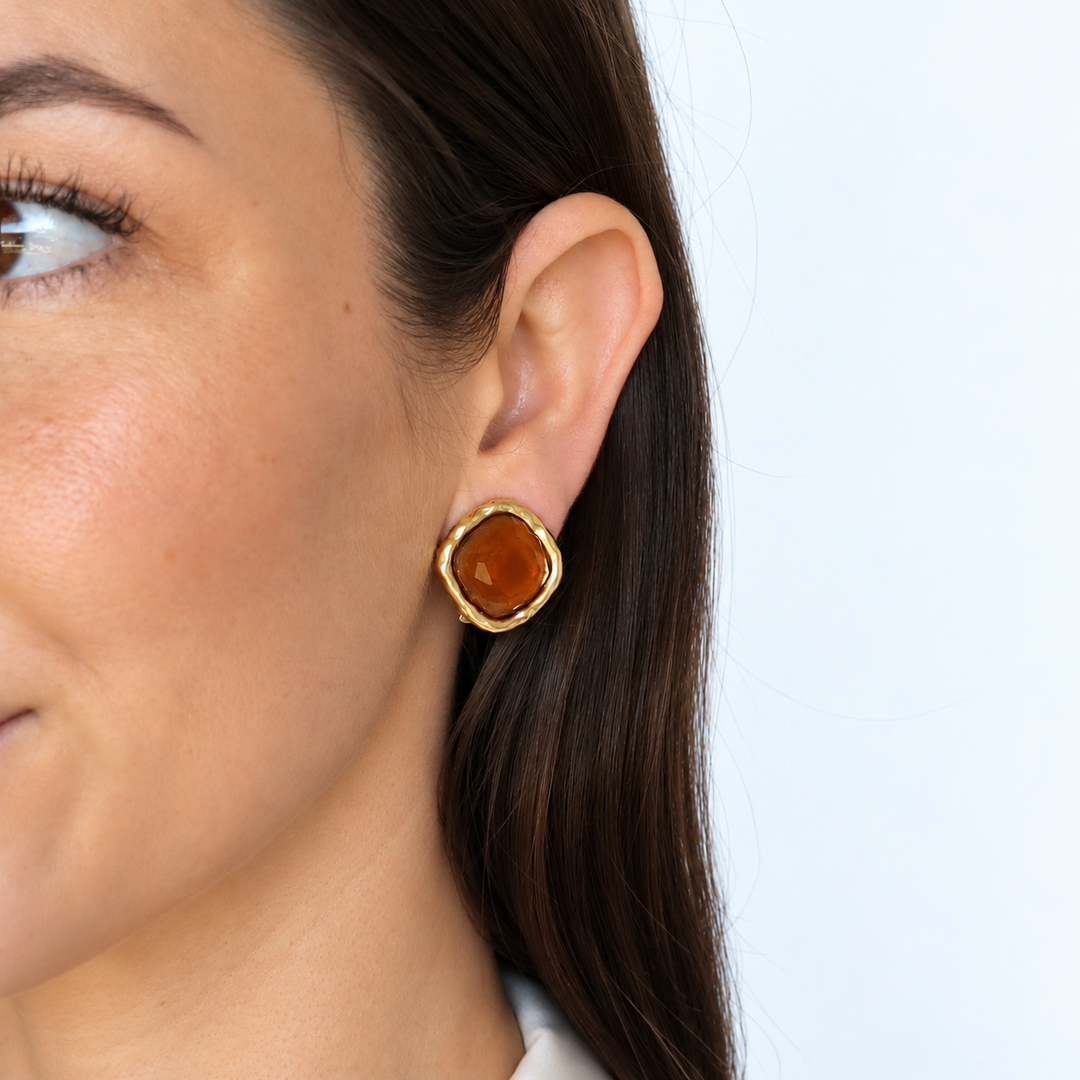 Espresso Bezel Clip-On Earring worn on brunette model showing warm brown glass and sculpted bezel