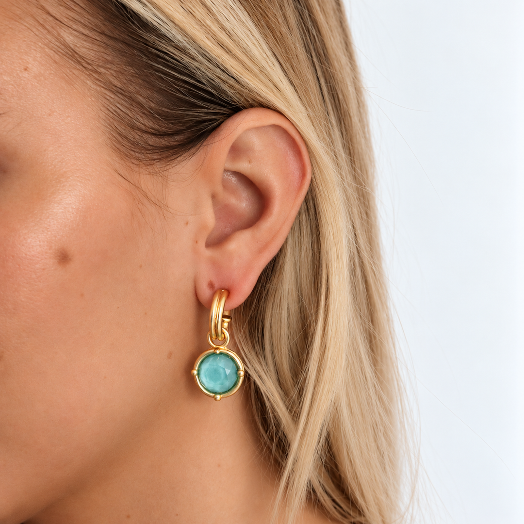 Iridescent Aquamarine Cabochon Charm Hoop Earrings worn showing turquoise glass and sculpted hoops