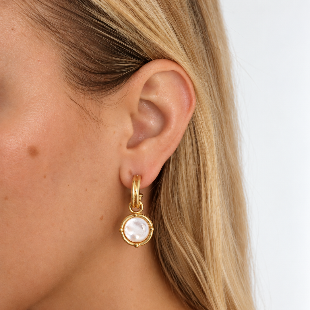 Mother of Pearl Cabochon Charm Hoop Earrings worn showing white pearlescent dangling discs