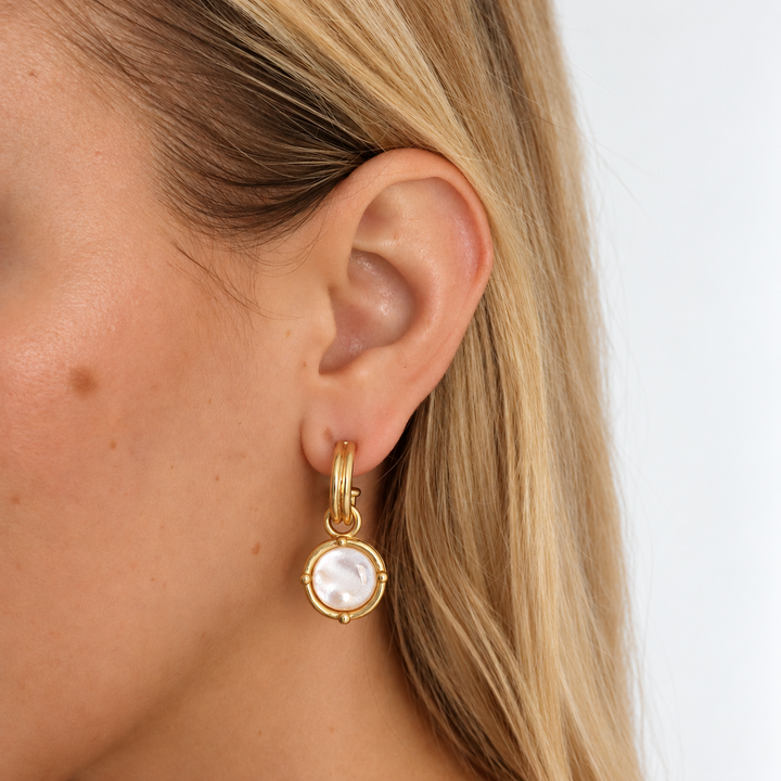 Mother of Pearl Cabochon Charm Hoop Earrings worn showing white pearlescent dangling discs