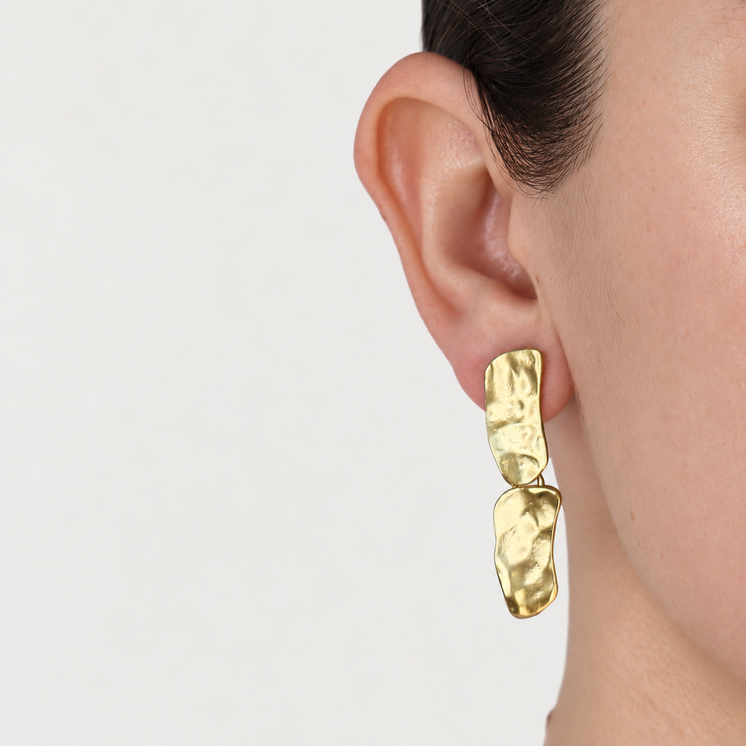 Gold Cobblestone Drop Clip-On Earring worn close up showing polished hammered texture