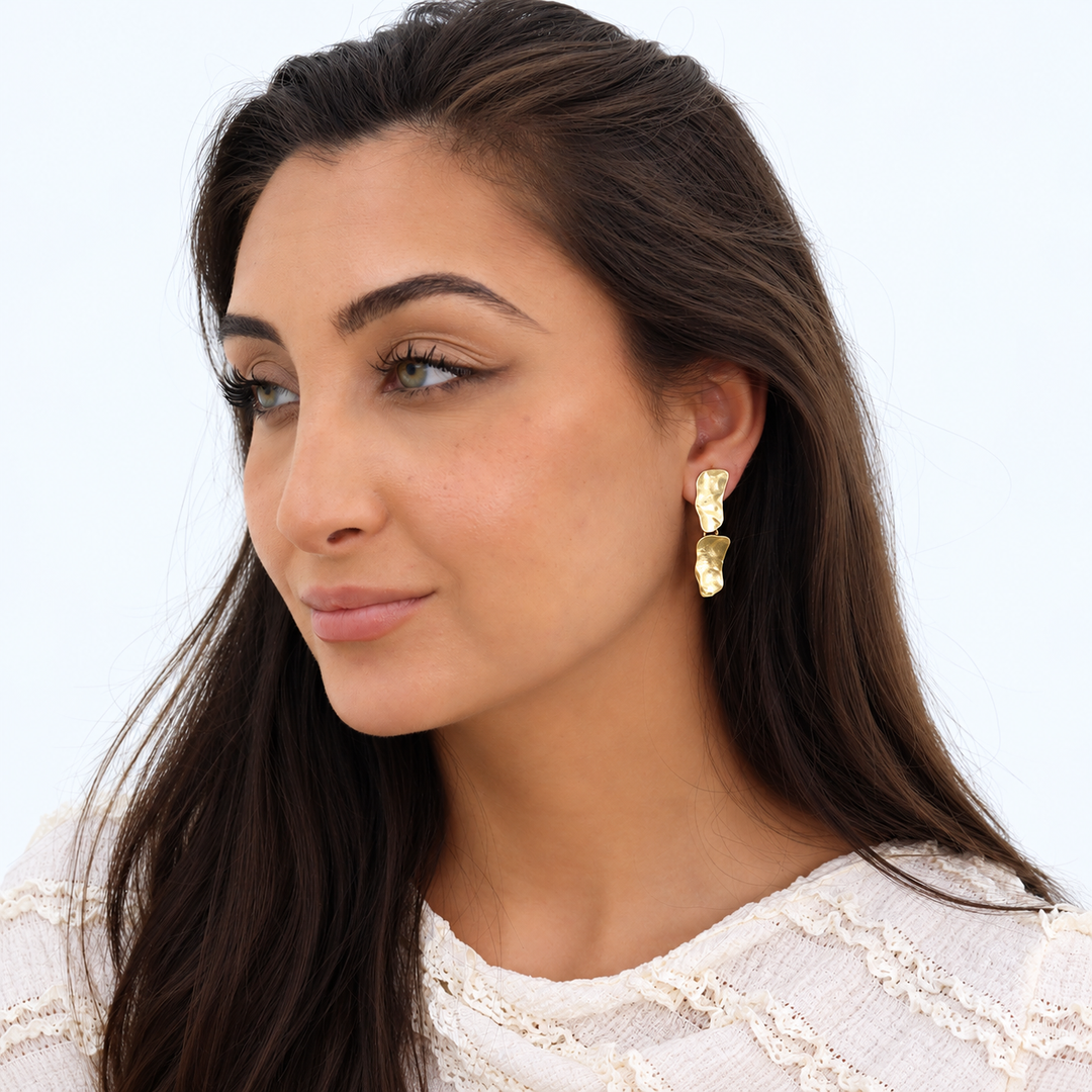 Gold Cobblestone Drop Earrings worn on brunette model with textured white blouse