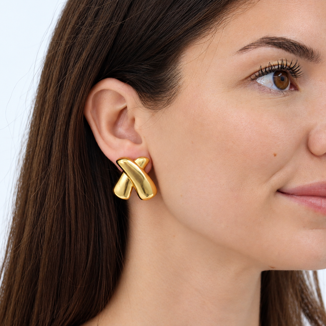 Crossed Clip-On Earring worn on brunette model showing bold rounded crossover design