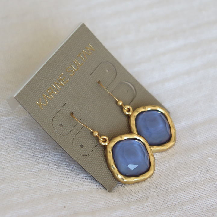 Soft Denim Blue Cushion Bezel Drop Earrings displayed on Karine Sultan card over fabric
