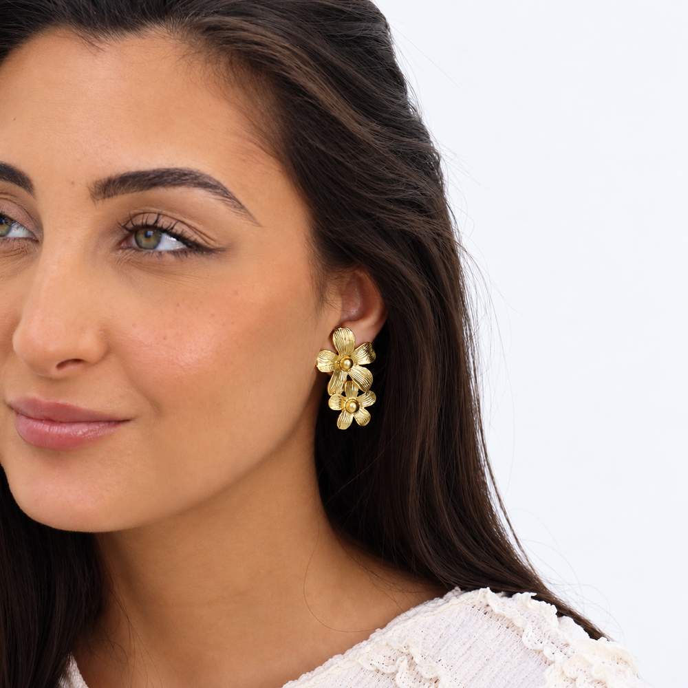 Gold Daisy Statement Drop Earring worn on brunette model showing cascading textured flowers