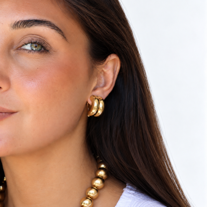 Double Curve Clip-On Earrings worn with coordinating gold plated beaded necklace
