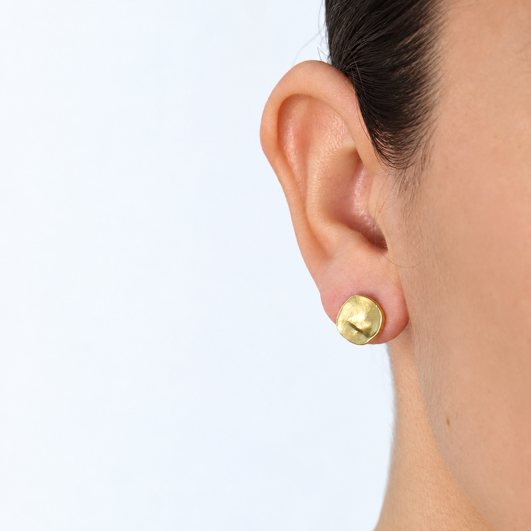 Gold Everyday Stud Earring worn close up showing subtle central crease and textured finish