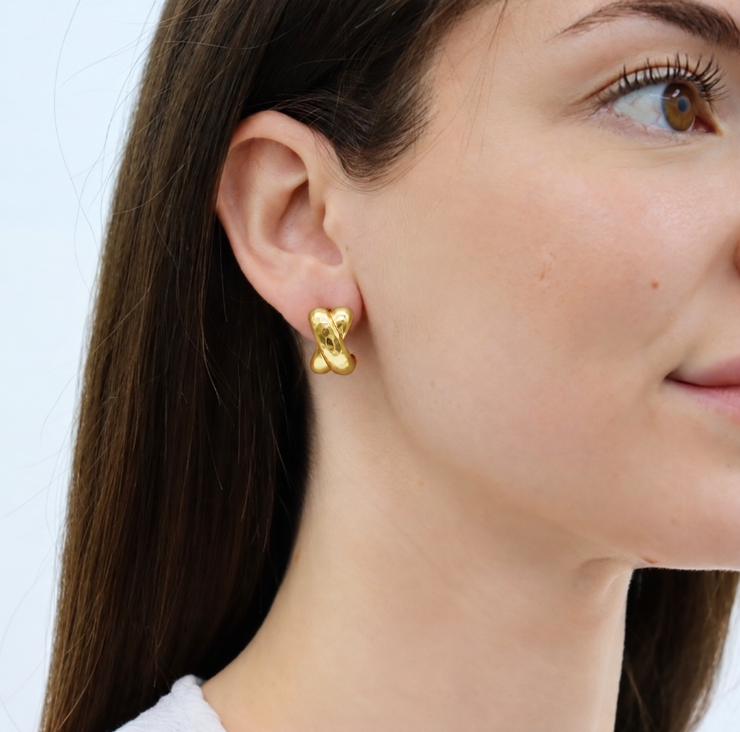 Hammered Cross Stud Earrings worn on model showing softly hammered sculptural design