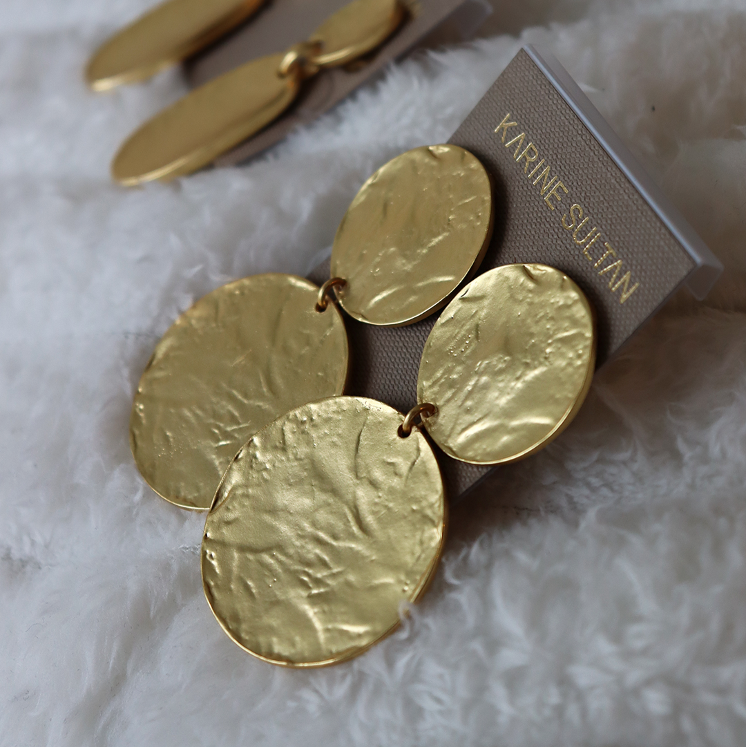 Gold Hammered Discs Clip-On Earrings displayed on Karine Sultan card over soft white fabric
