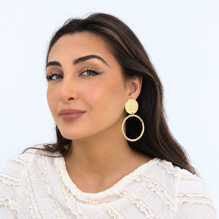 Loopa Clip-On Earring worn on brunette model showing oversized open gold circle pendant