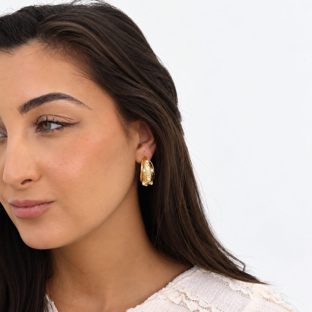 Mademoiselle Pearl Hoop Earring worn on brunette model showing textured gold and pearl details