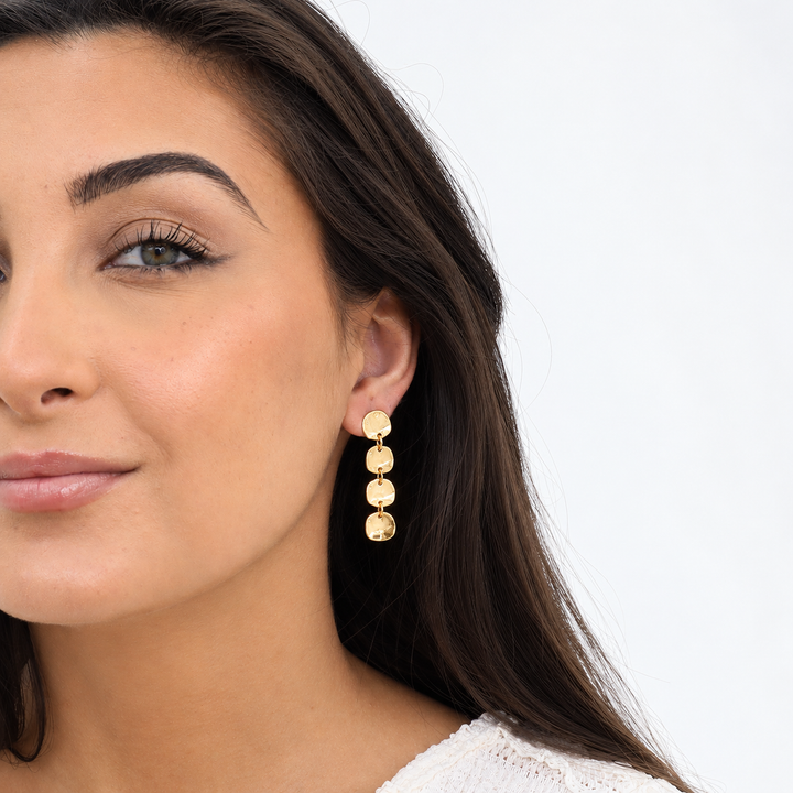 Gold Mini Coin Linear Drop Earring worn on brunette model showing four cascading discs