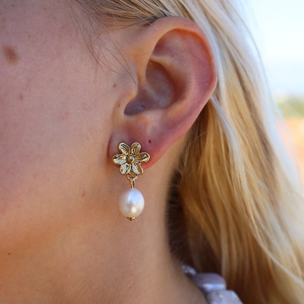Mini Daisy Pearl Drop Earring worn on blonde model showing gold plated flower stud