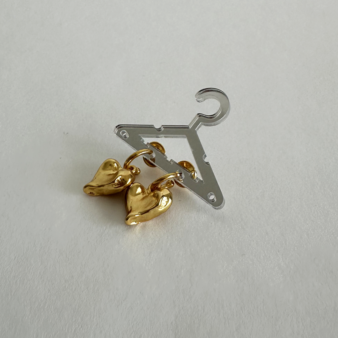 Molten Heart Drop Earrings displayed at an angle showing sculpted gold plated hearts