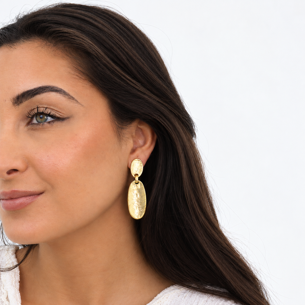 Gold Oval Plate Drop Earring worn on brunette model showing elongated hammered discs