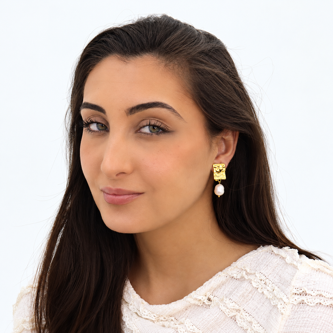 Gold Pearl Drop Clip-On Earrings worn on brunette model with textured rectangular tops and faux pearls