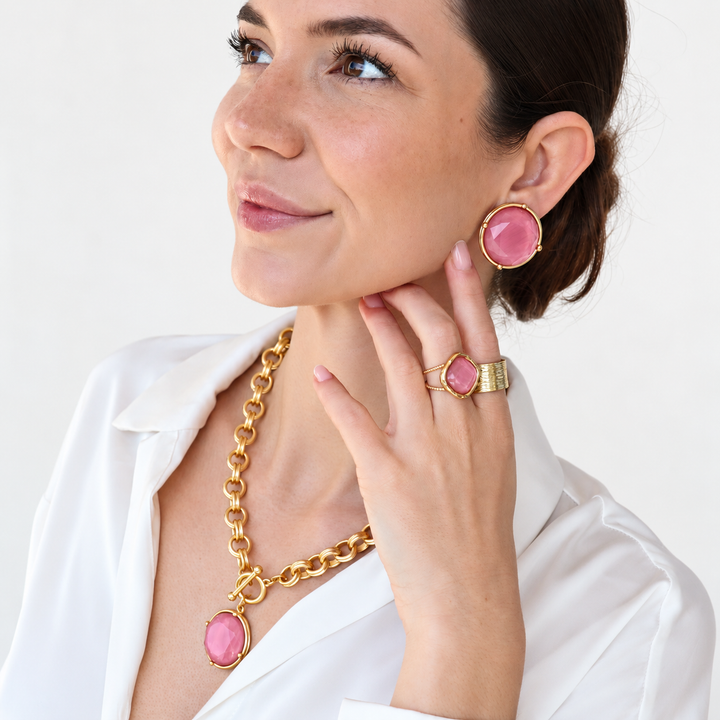 model wearing pink stone and gold jewelry set