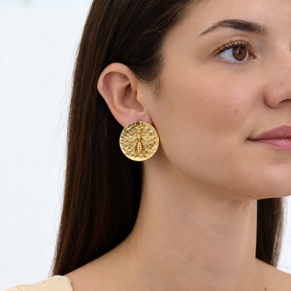 Queen Bee Clip-On Earrings worn on model showing oversized hammered coin design
