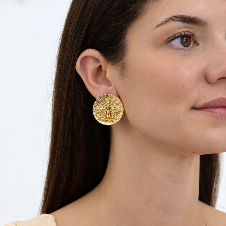 Queen Bee Clip-On Earrings worn on model showing oversized hammered coin design