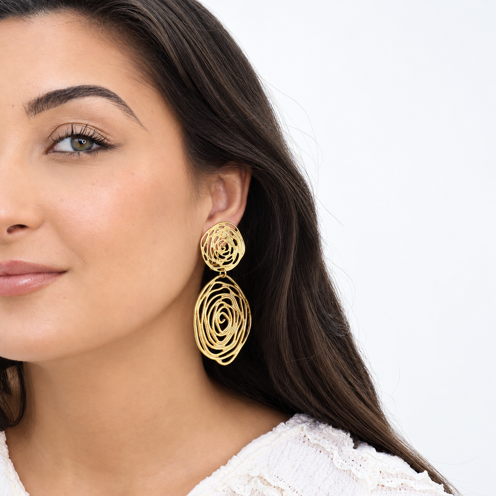 Gold Rose Cut Out Statement Earring worn on brunette model with white textured blouse
