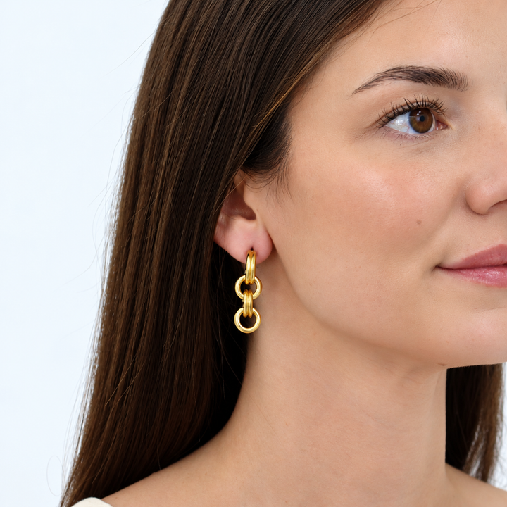 Rounded Chain Drop Earring worn on brunette model showing polished interlocking gold links