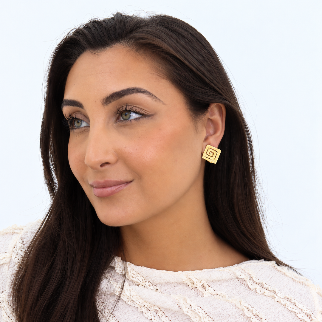 Gold Square Spiral Stud Earring worn on brunette model showing geometric spiral shape