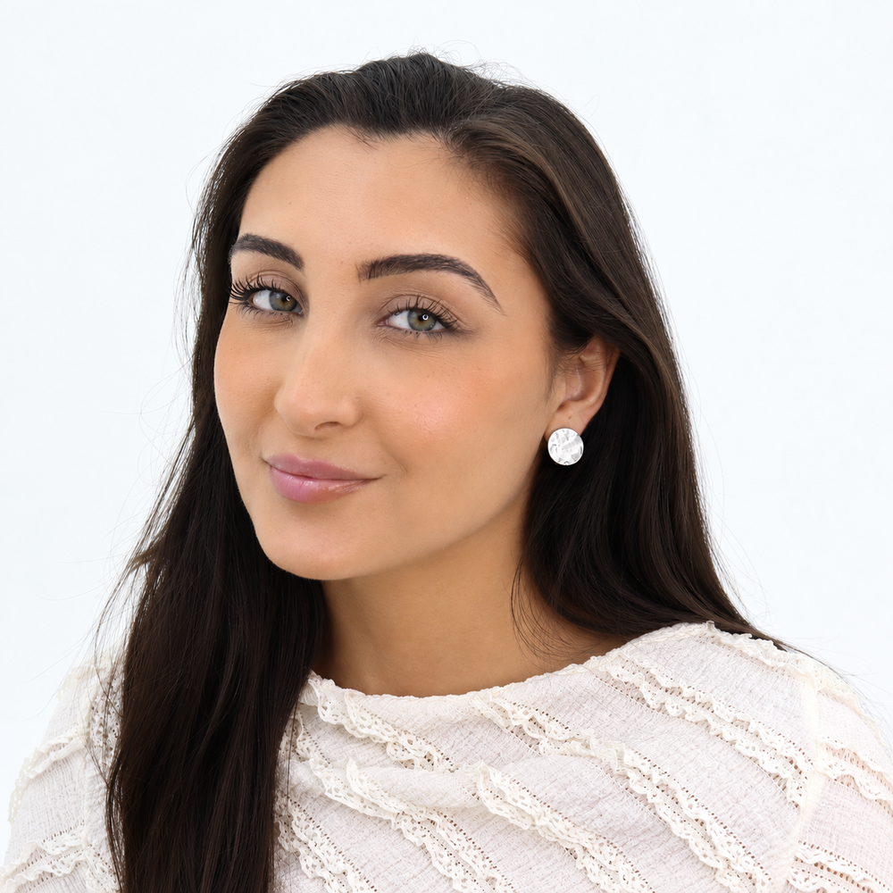 Silver Textured Coin Clip-On Earrings worn on brunette model with white lace blouse