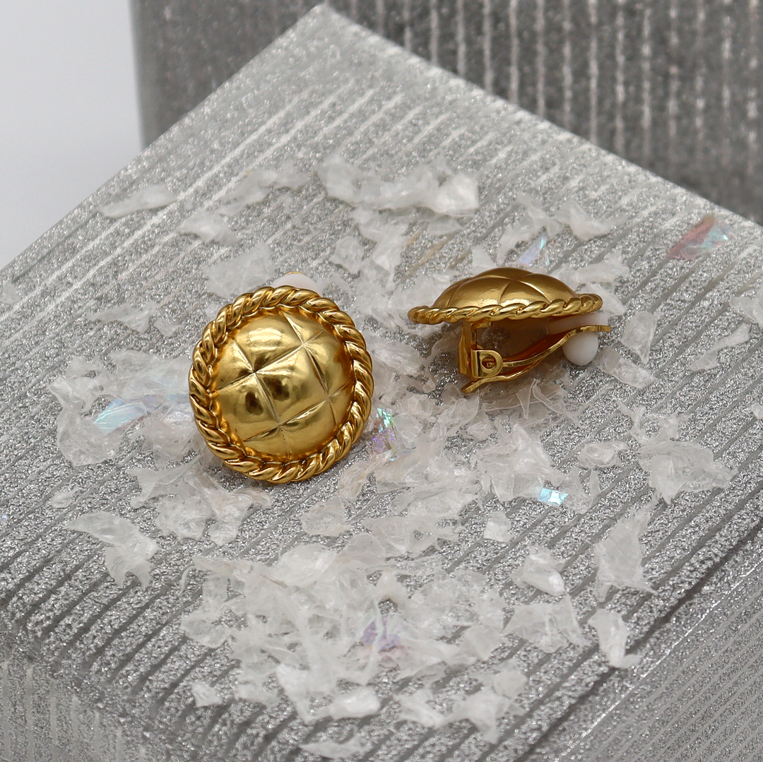 Tufted Texture Clip-On Earrings displayed on silver surface showing rope borders and padded closures