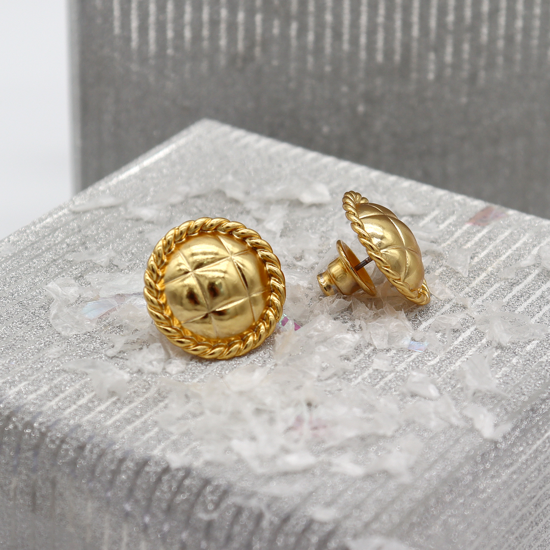 Tufted Texture Stud Earrings displayed on textured silver surface showing post-back closures