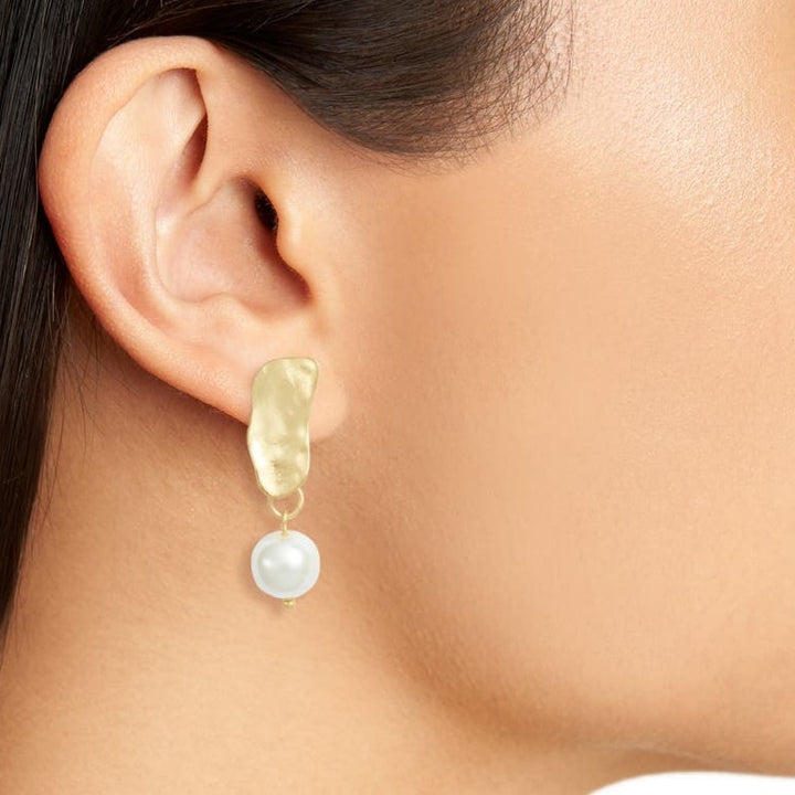 Gold Cobblestone Pearl Clip-On Earring worn close up showing textured metal and pearl drop