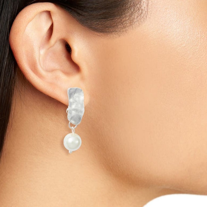 Silver Cobblestone Pearl Clip-On Earring worn close up showing irregular metal and white pearl