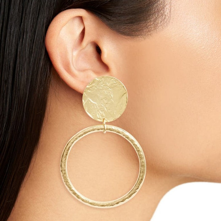 Loopa Clip-On Earring worn close up showing textured gold disc and oversized circular drop