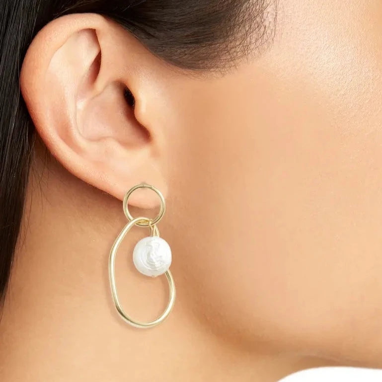 Organic Link Pearl Drop Earring worn on model showing flat freshwater pearl and elongated gold link